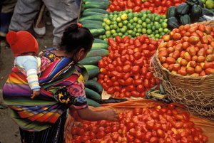 Woman and child buying produce in a market